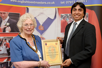 Harish Patel receiving his Honorary Fellow membership certificate from the Chairman of Essex County Council, Councillor Elizabeth Hart at the County Hotel, Chelmsford