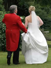 Essex wedding toastmaster Richard Palmer assisting the bride with her wedding dress at the Park Hotel, Lakeside, Essex